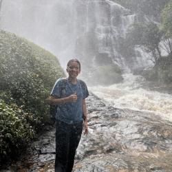 Person with a waterfall in the background
