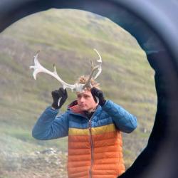 evan inside a rubber circle putting antlers on his head