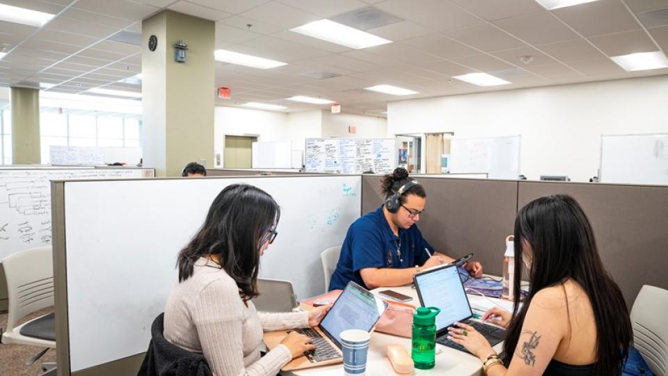 Three students studying in a student centered space in the Humboldt library.