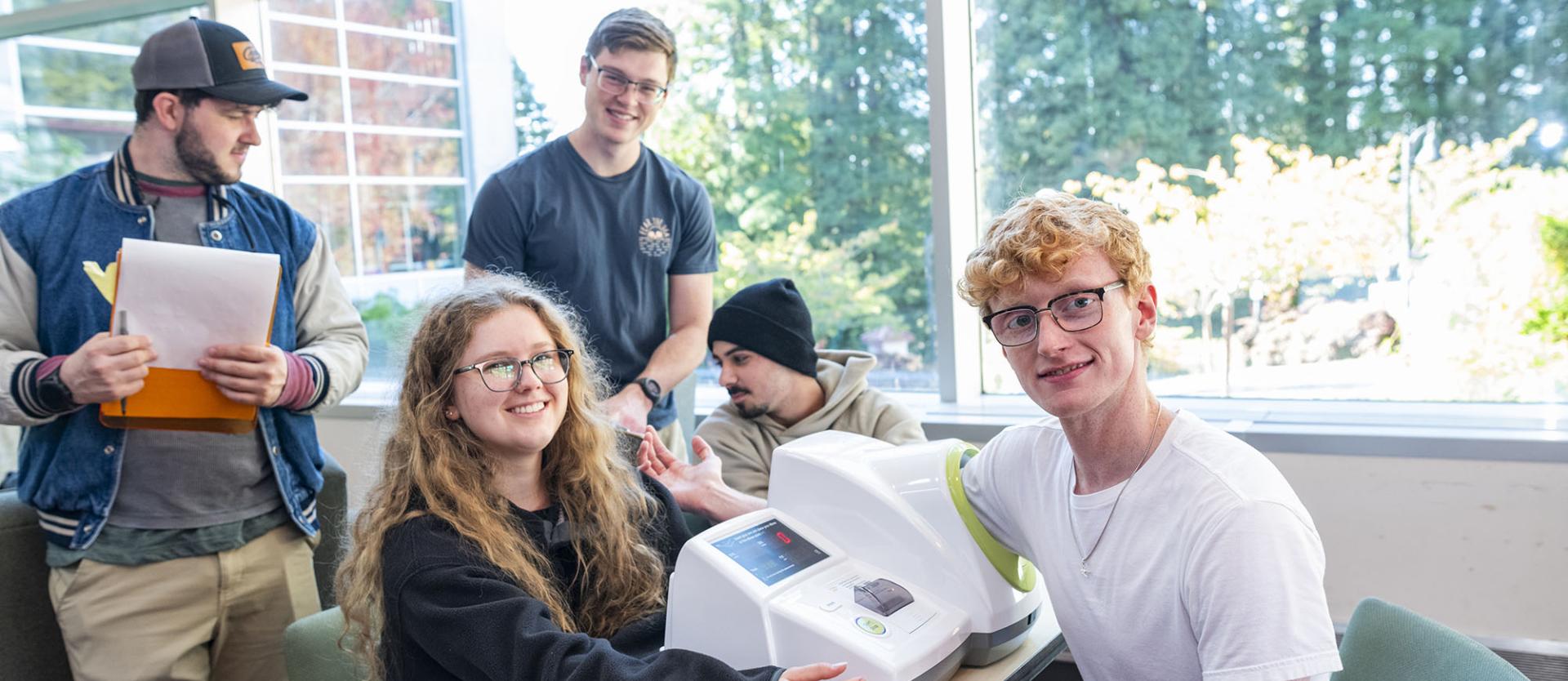 Students using a blood pressure monitor