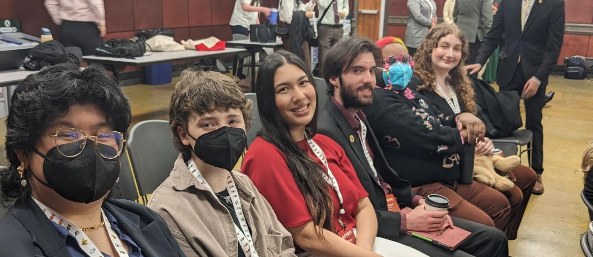 Six students sit in a row at the CSSA Plenary meeting in Sacramento