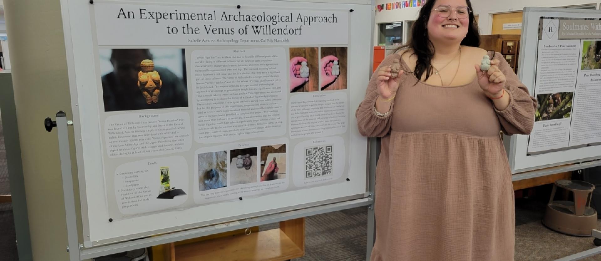 a student in a brown dress standing in front of a presentation board with images and text on it