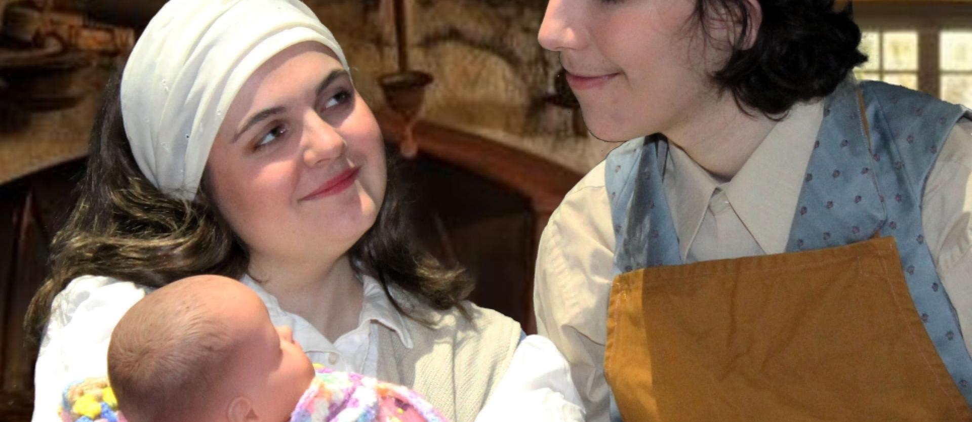 bakers wife with doll and baker standing next to her