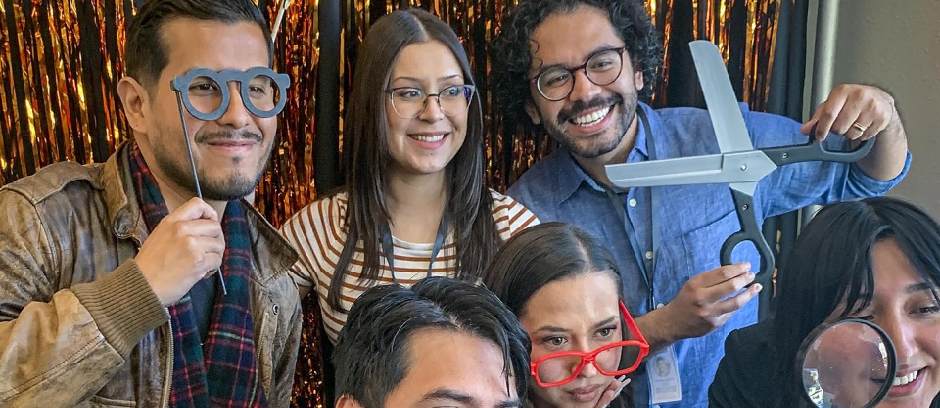 students in a photo booth with props