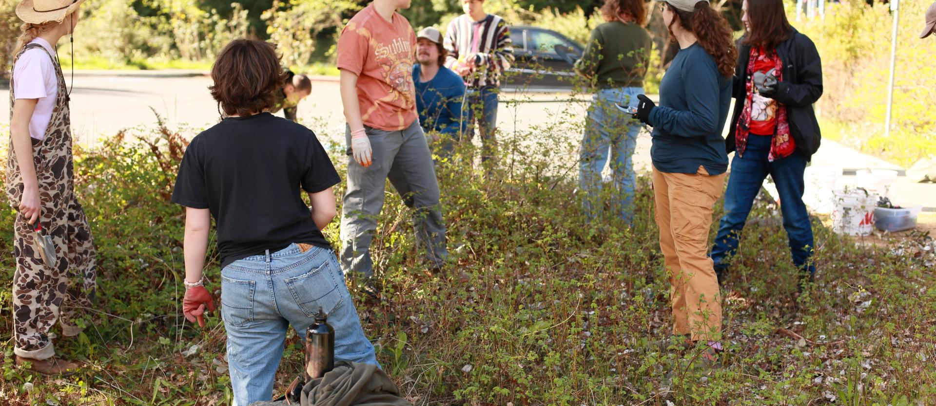 Image of 7 FSL Volunteers assisting with FSL staff to clean and clear the Salmon Cooking Pit area.