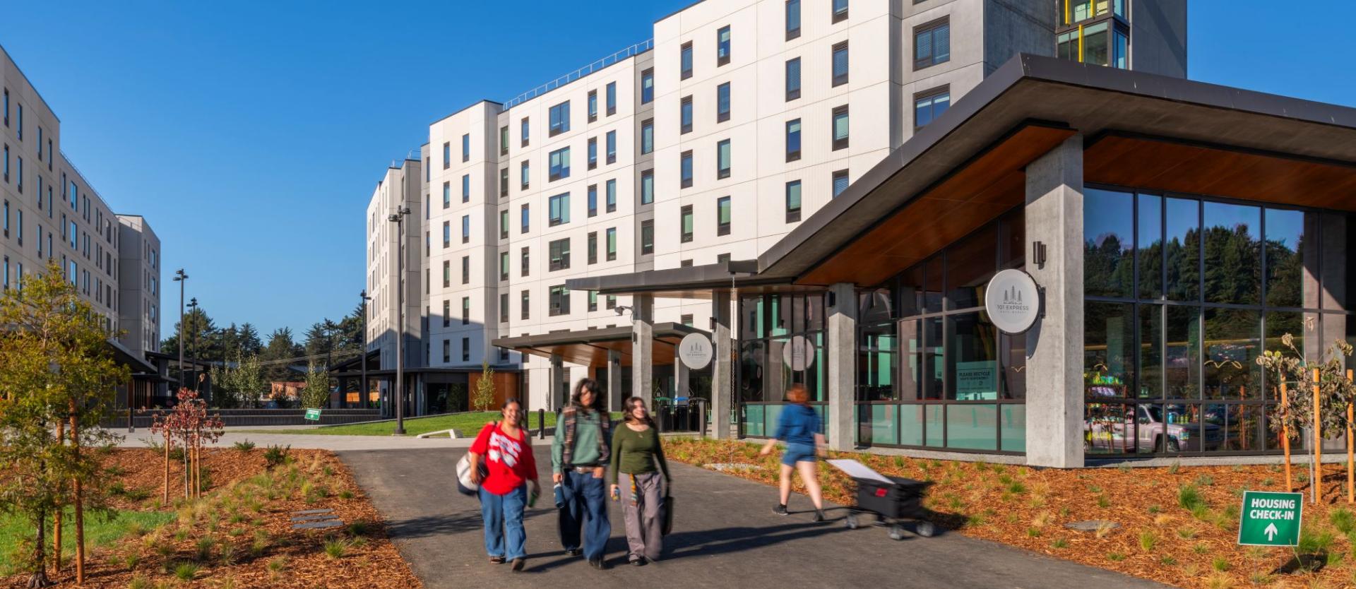 exterior of apartments and market and people walking
