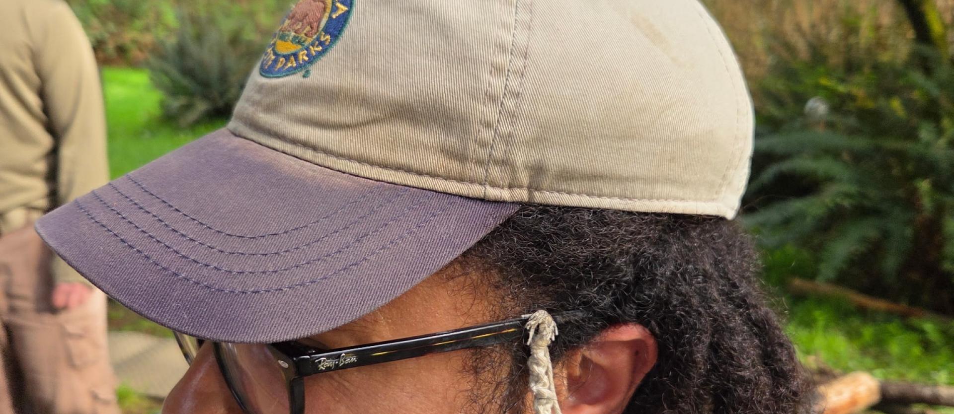 A butterfly perched on Kyle's cap.
