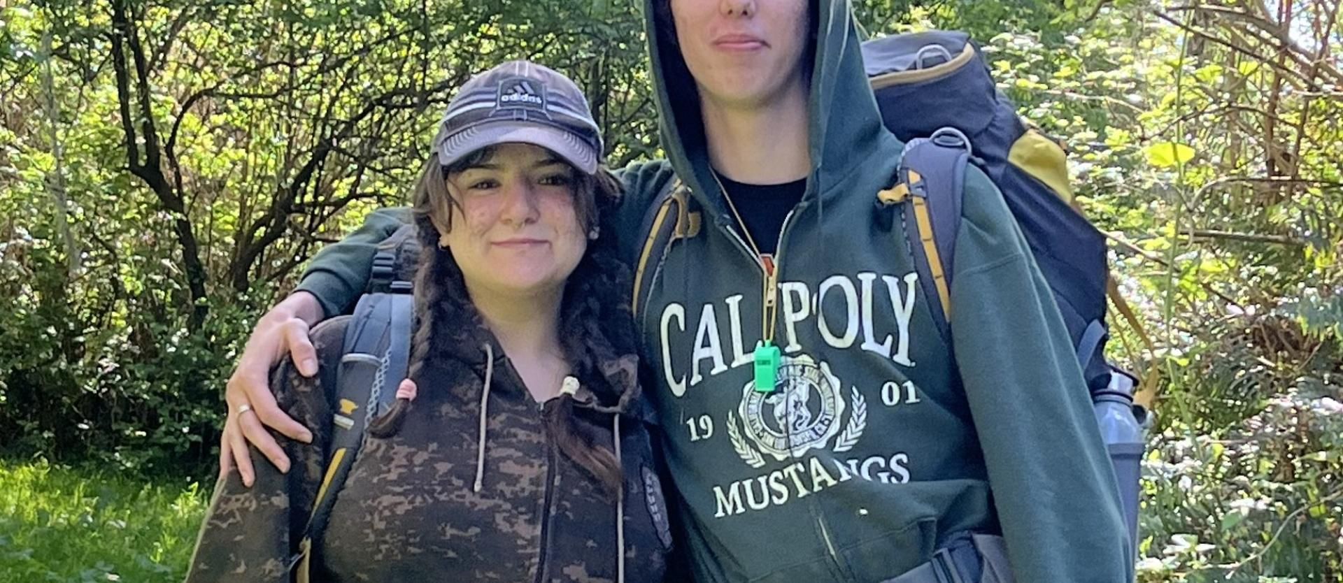 Backpacking couple posing for a morning picture in the Forrest.