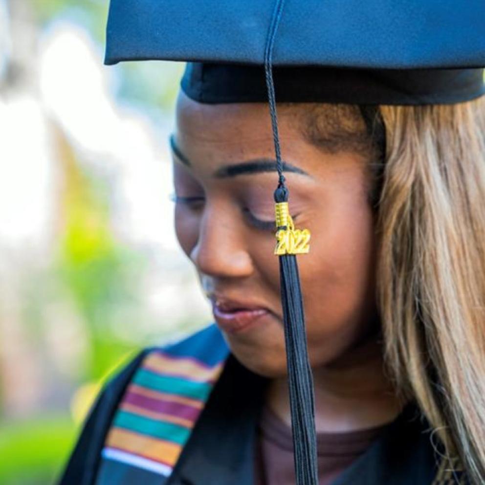 close up of a student outside wearing cap and gown