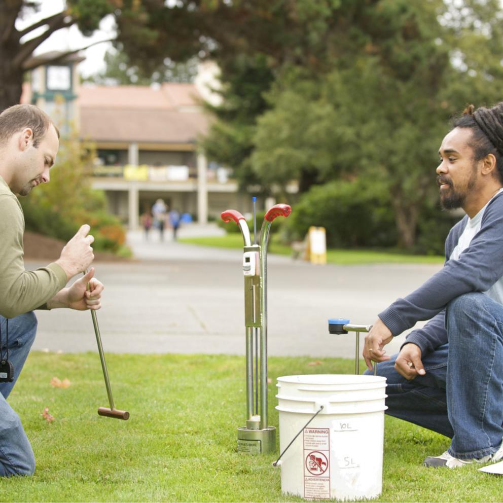 Two students working in the field