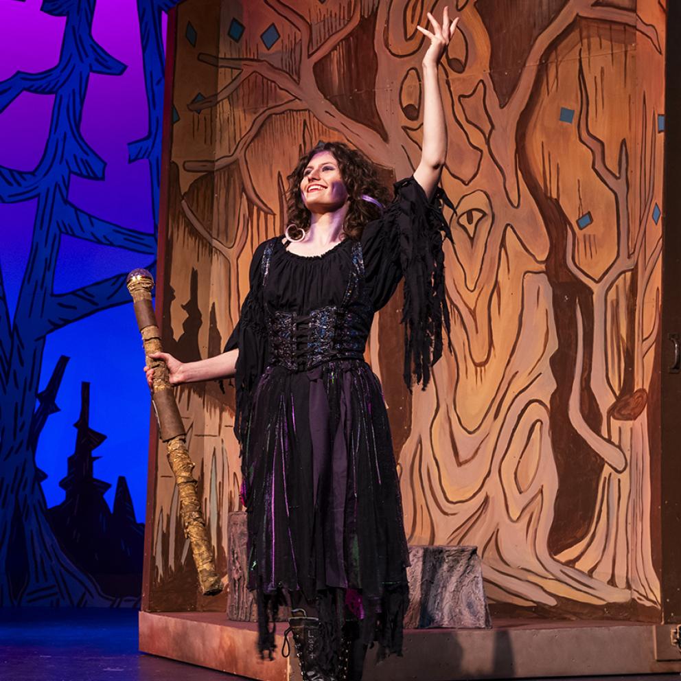 a women dressed as a witch acting on stage