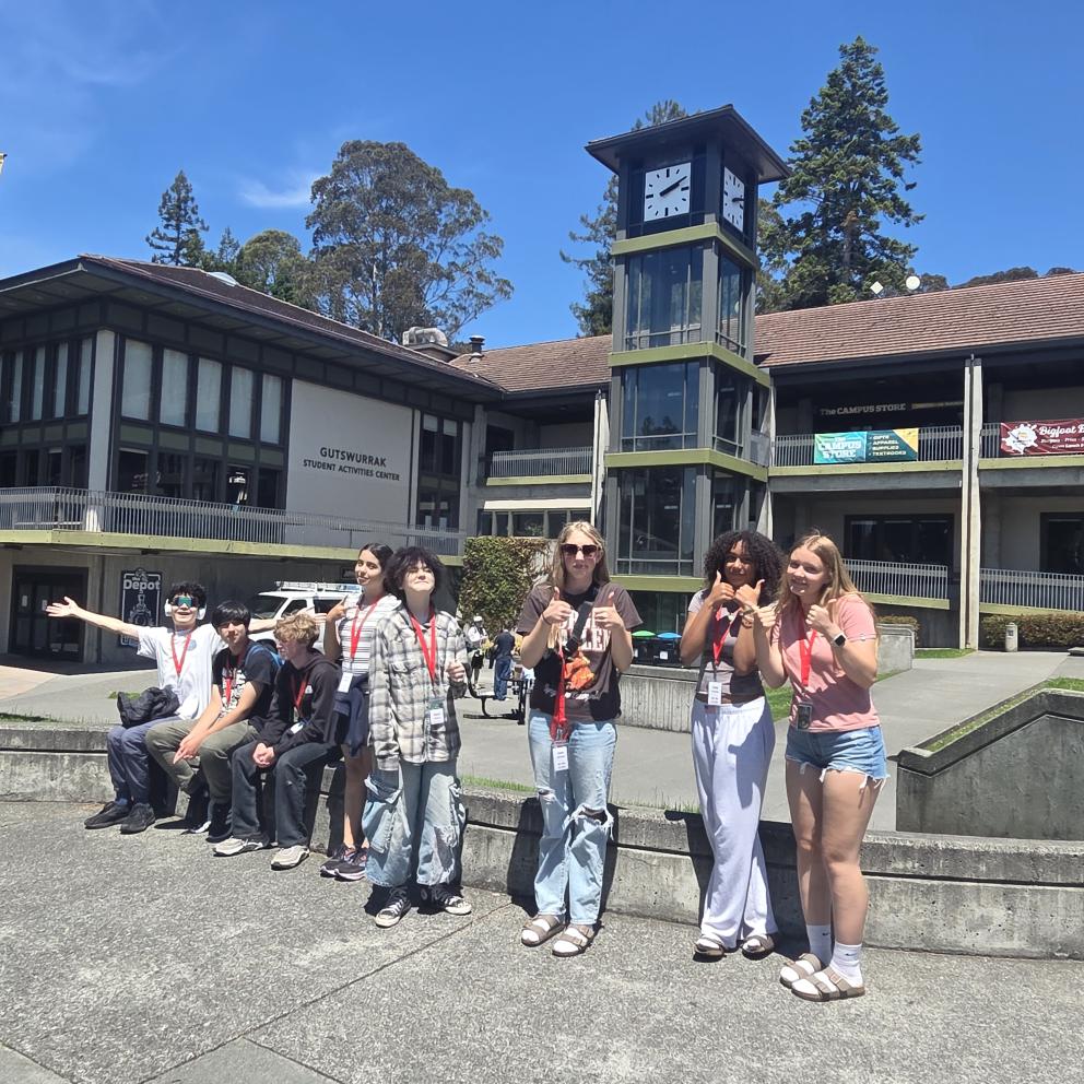 Humboldt students posing in front of the University Clocktower