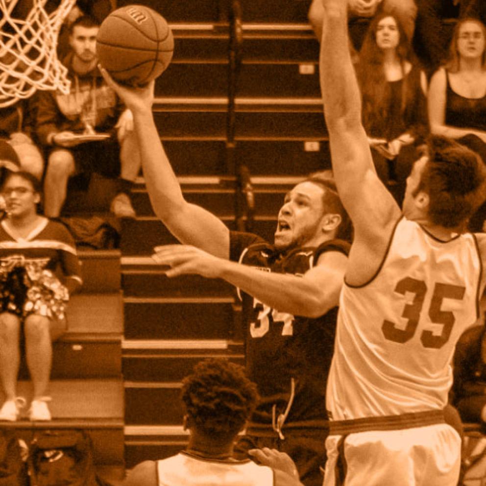 Men play ing basketball