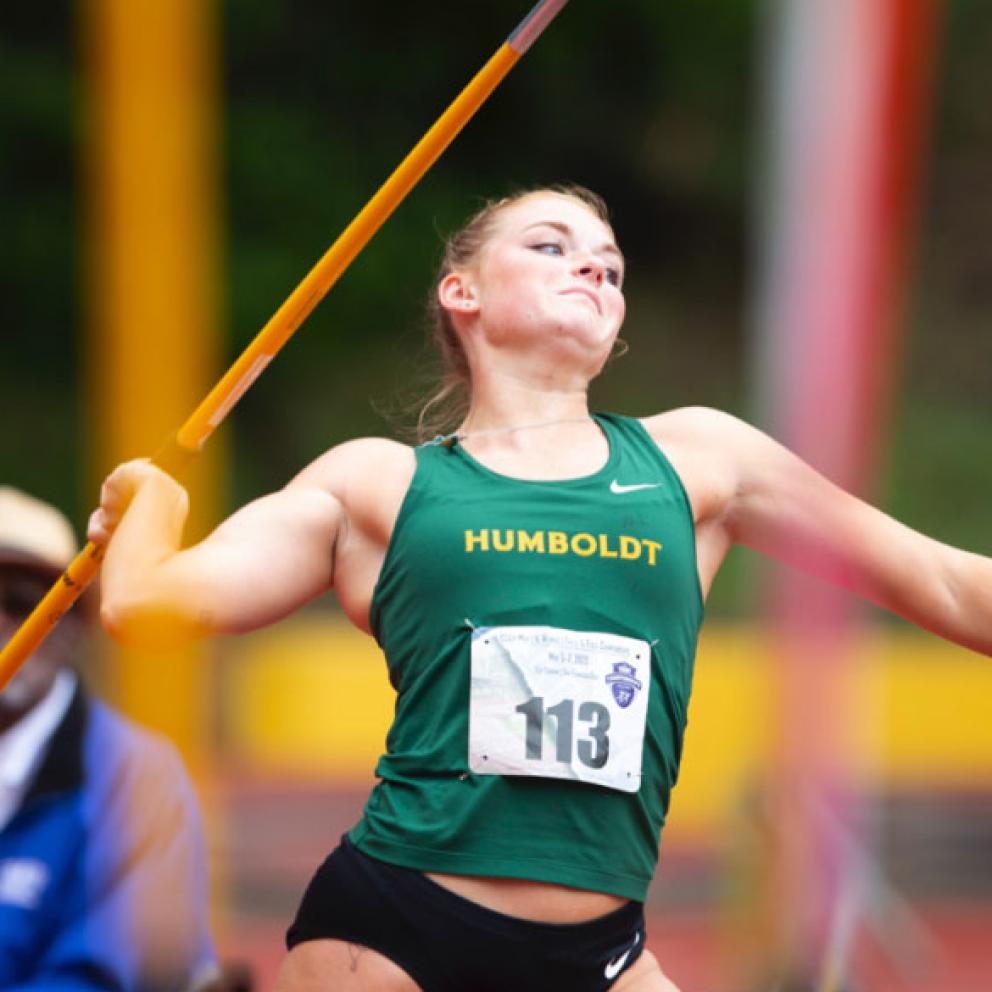a woman running with a large pole