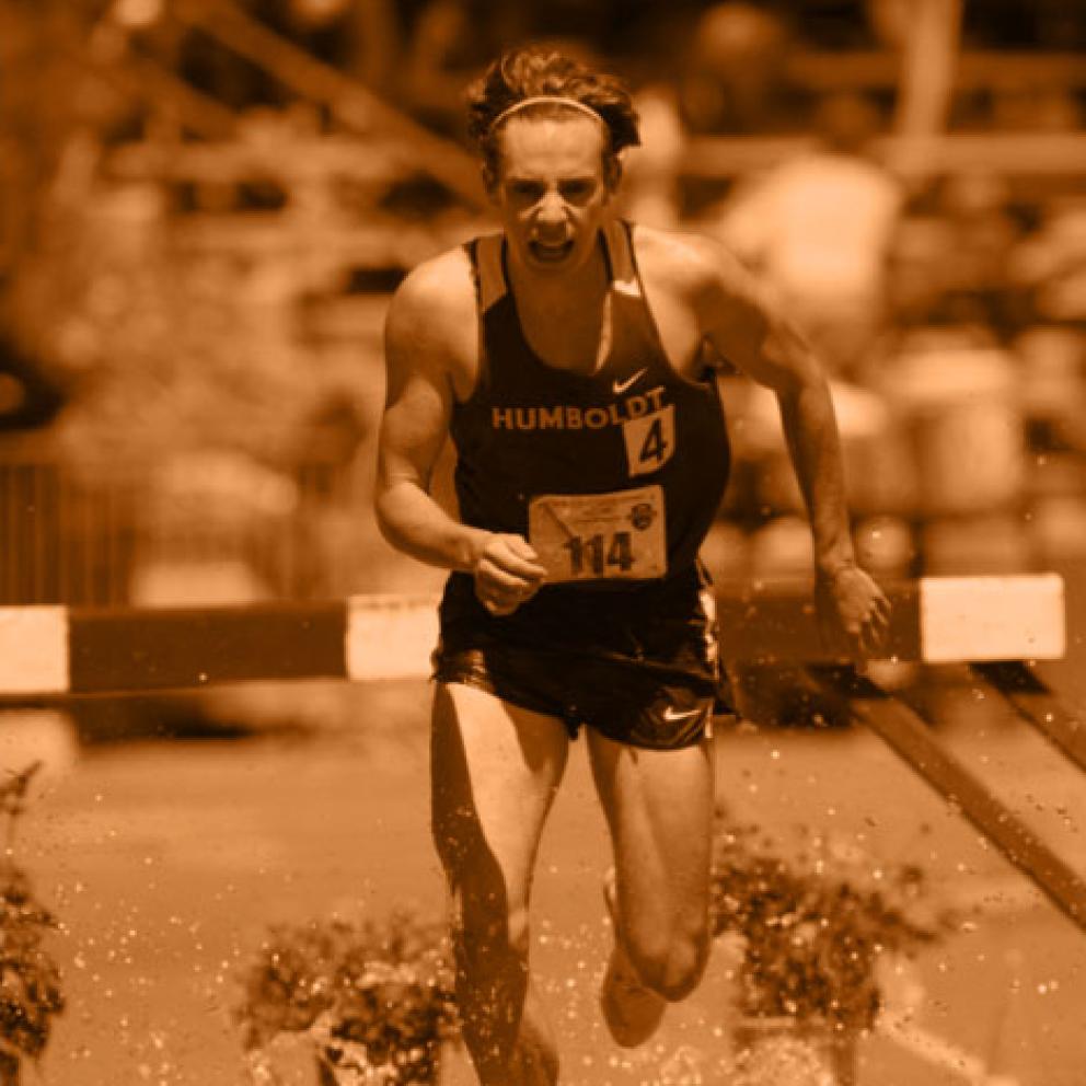 A man running on the track in the rain