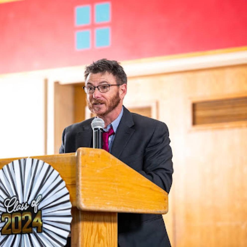 Dr. Loren Cannon standing at a podium.