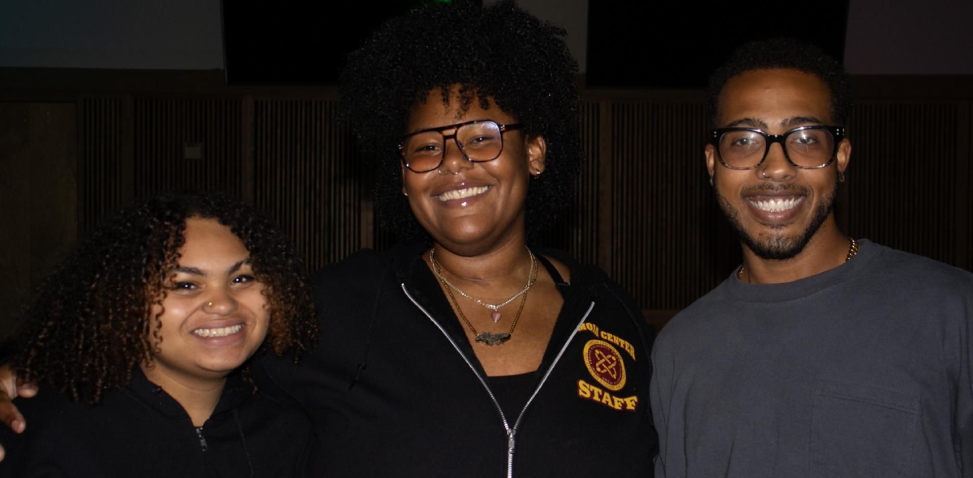 Two Umoja students pose with Umoja Center Coordinator.
