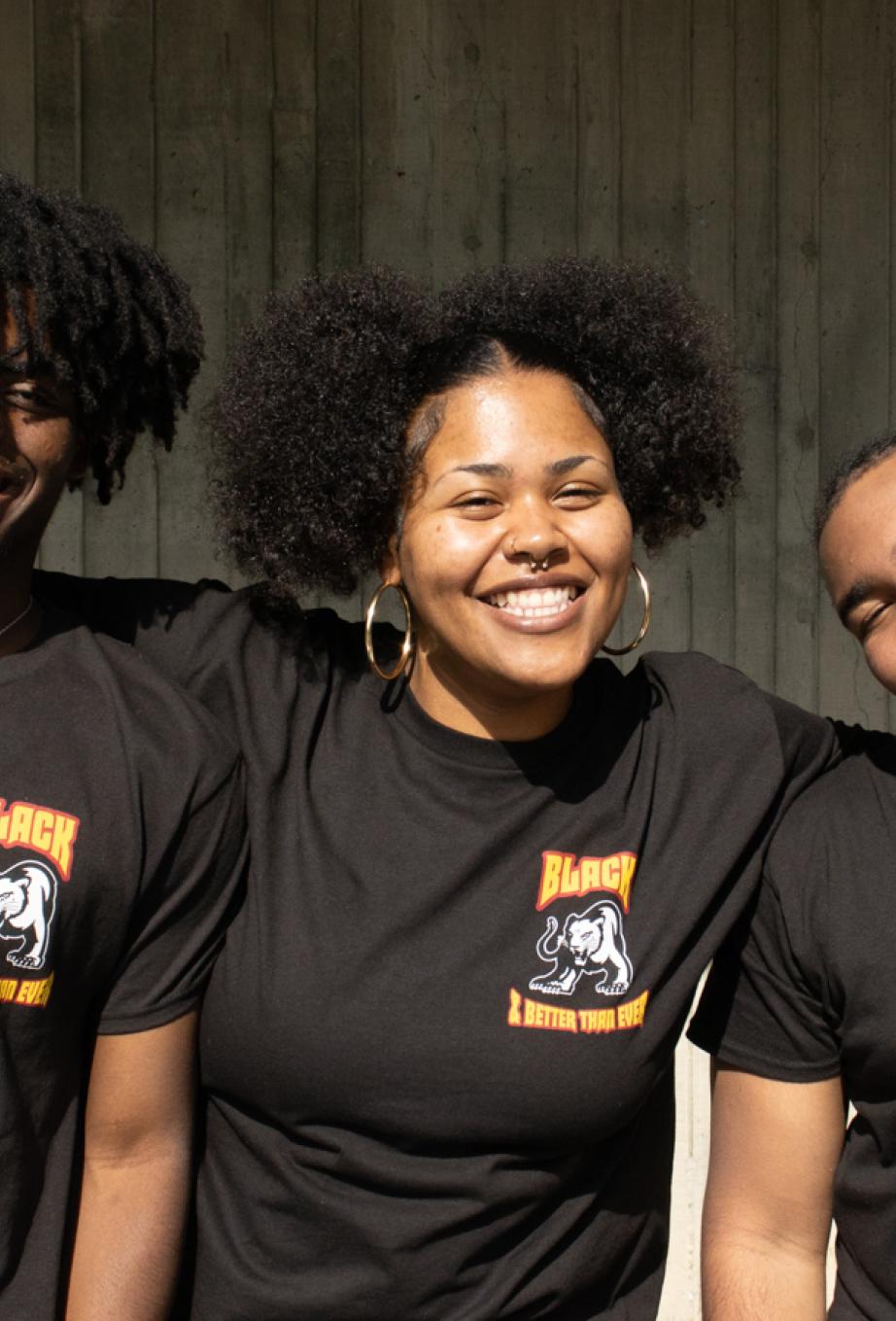 Three Umoja Student Staff smile for a photo in the SAC Lower Quad