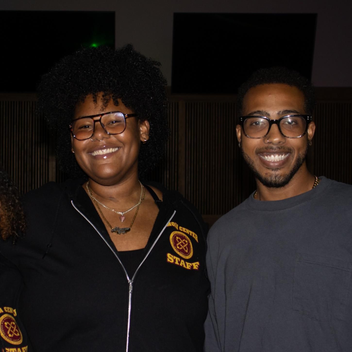 Two students pose with Umoja Center coordinator at Black Student Mixer