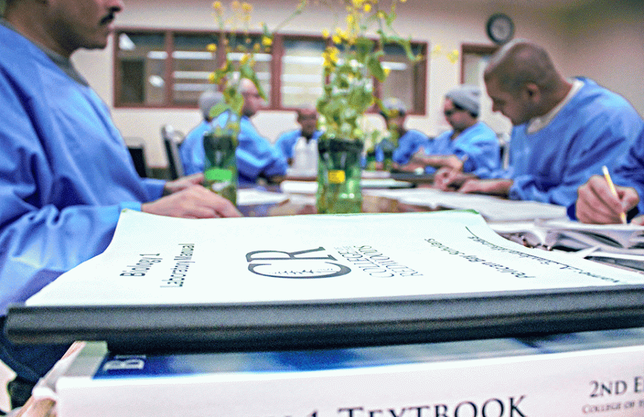 Pelican Bay scholars studying at table with textbooks on it