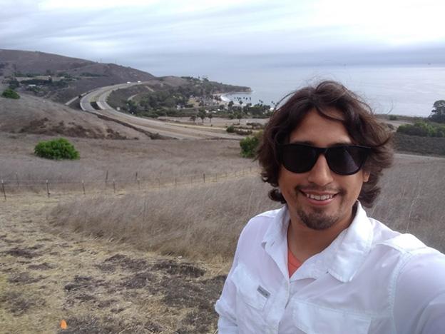 A photo of Ariel DeLara wearing sunglass near a beach. 