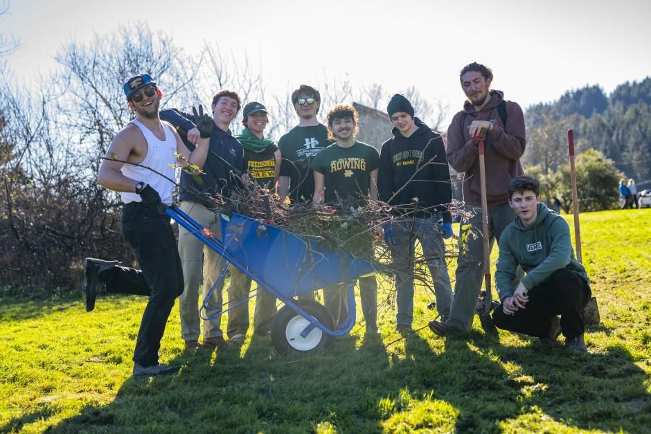 Group photo of 8 smiling student volunteers