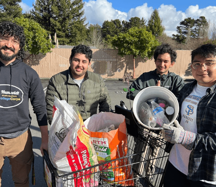 Students showing debris collected at a site.