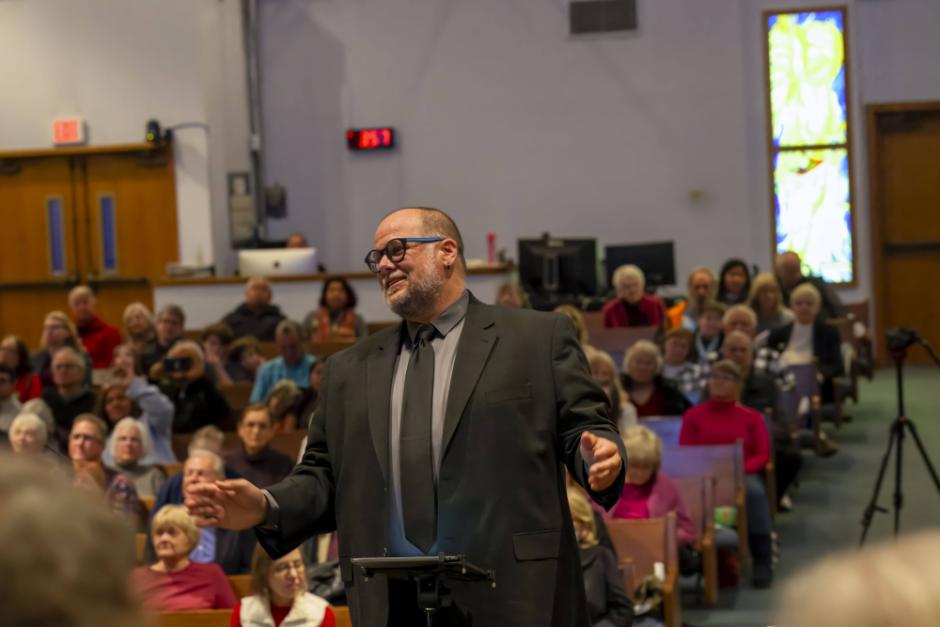 A photo of Jon Souza conducting 