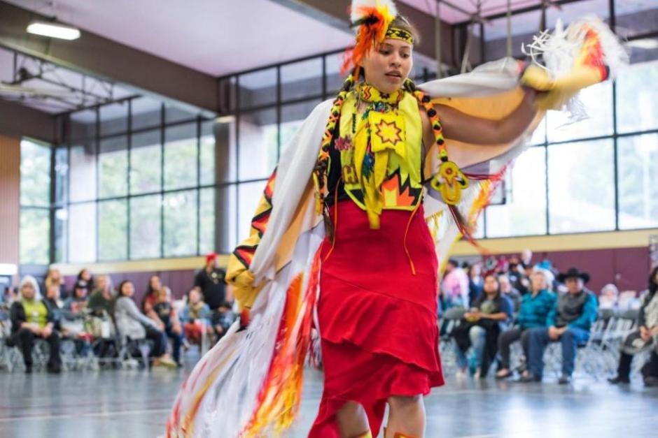 Student in regalia performing at Big Time