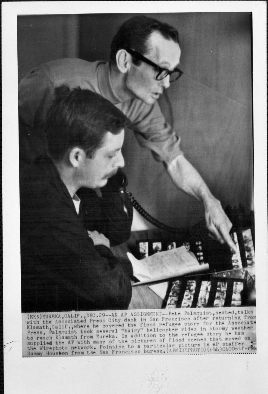 Peter Palmquist at a work desk looking at photographs