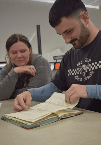 students reading old letters