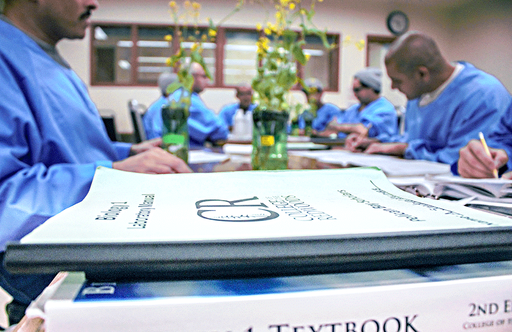 Pelican Bay scholars studying at table with textbooks on it