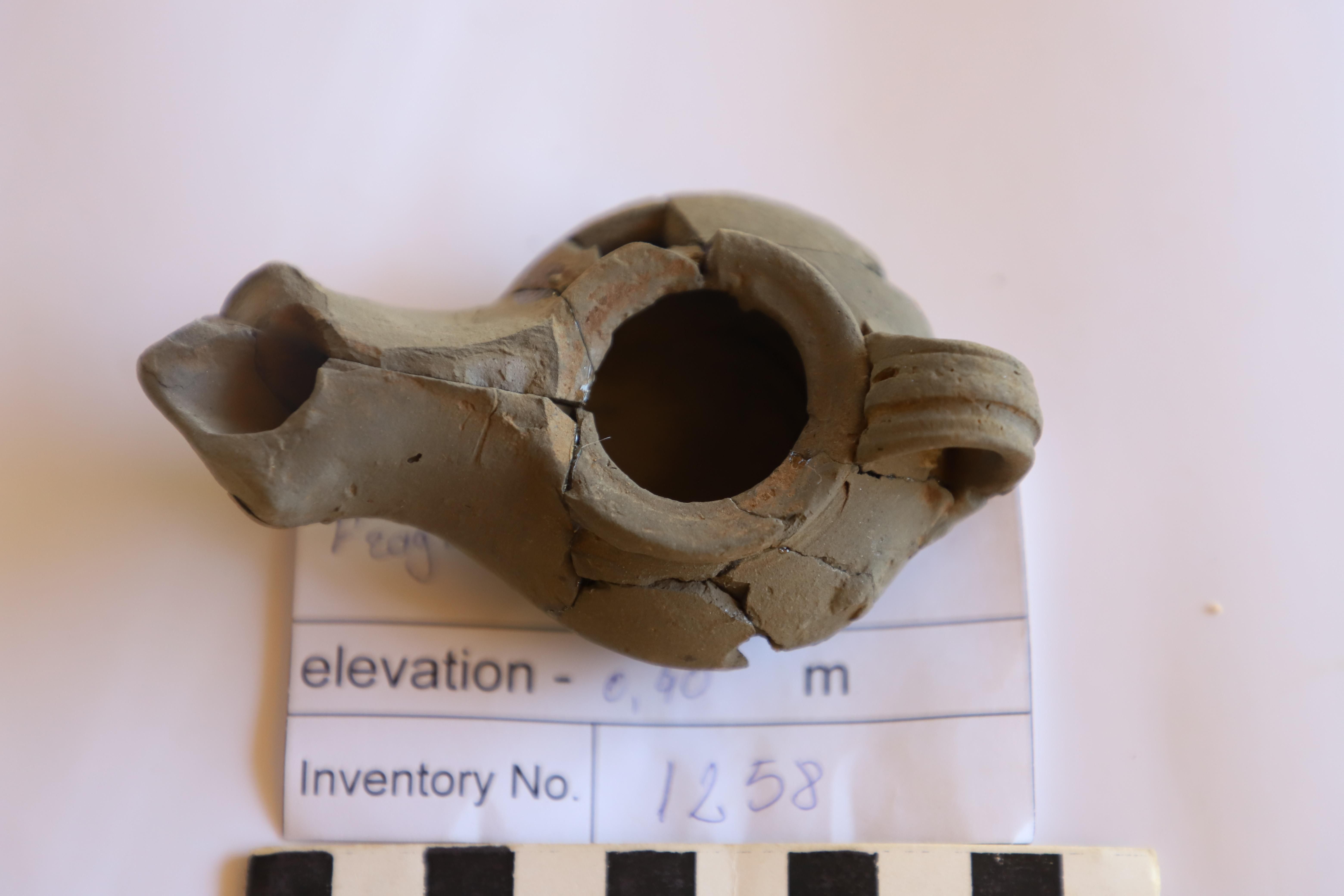 a 2,000-year old oil lamp with small cracks 