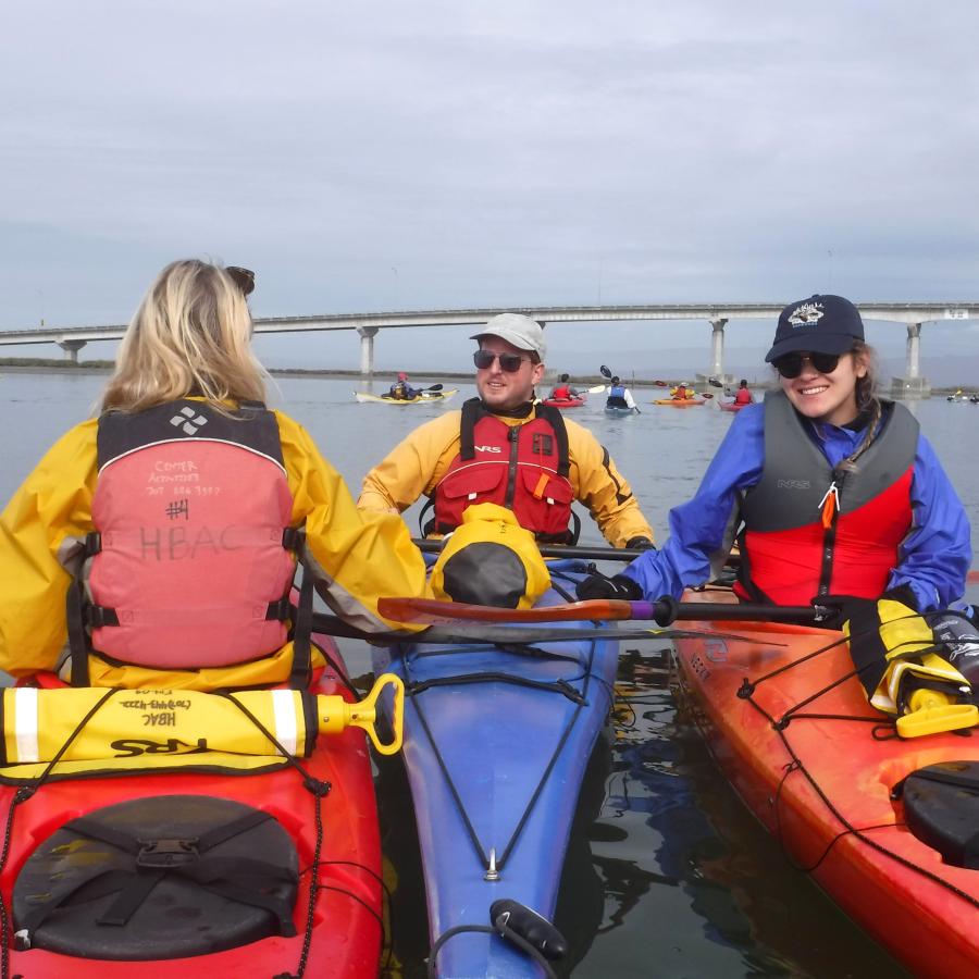 Kayak guide and two students in kayaks on Humboldt bay