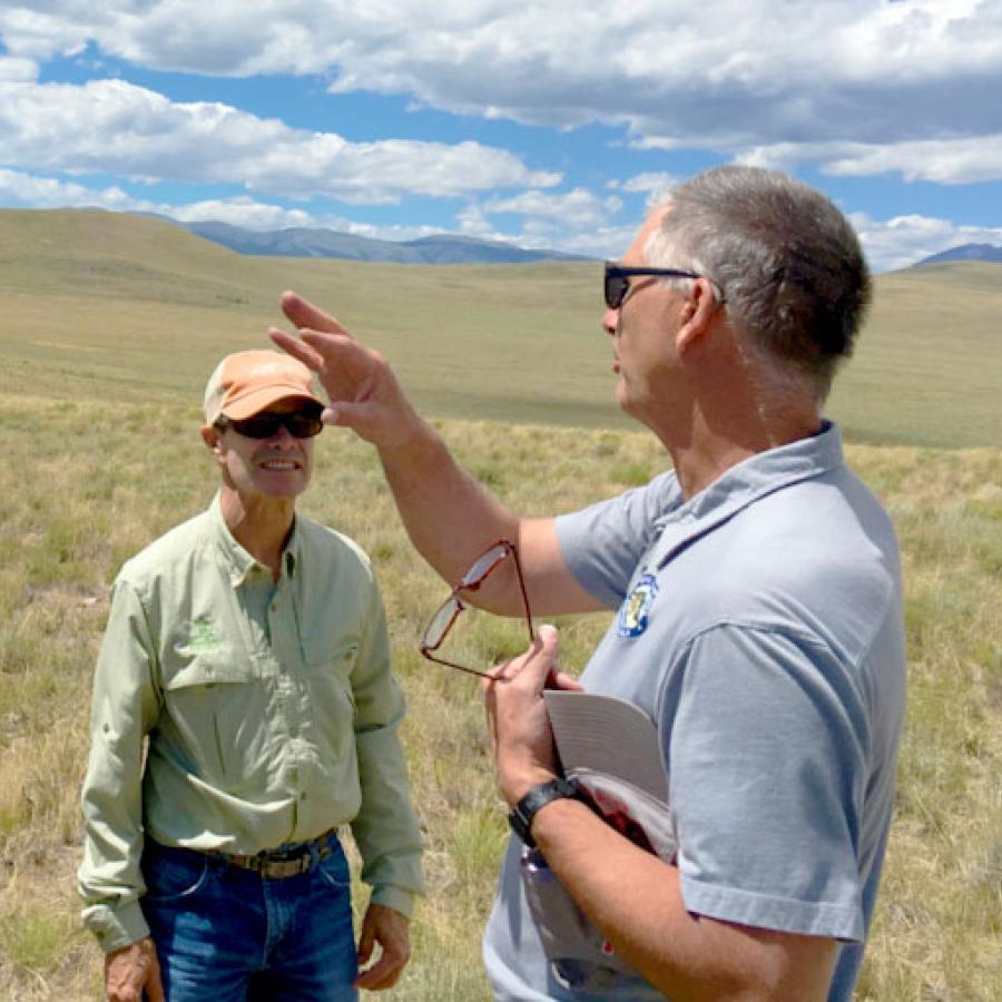 Two men having a meeting on a ranch