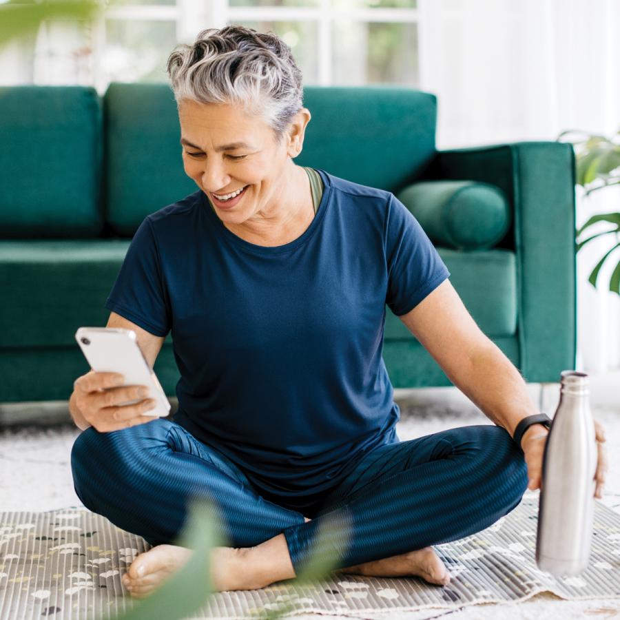 Woman checking her health app on her phone, after exercising