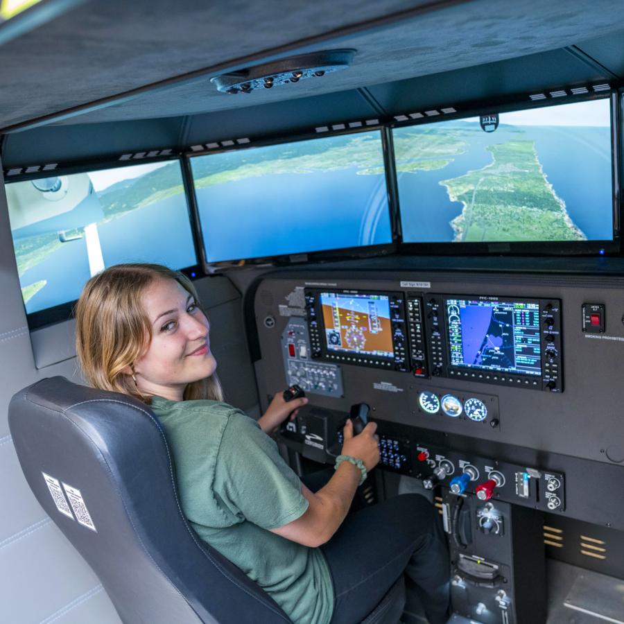 Woman running the library's flight simulator