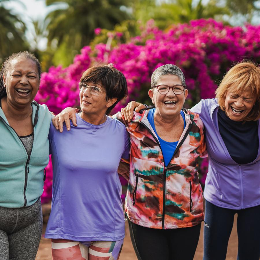 Four women friends laughing together