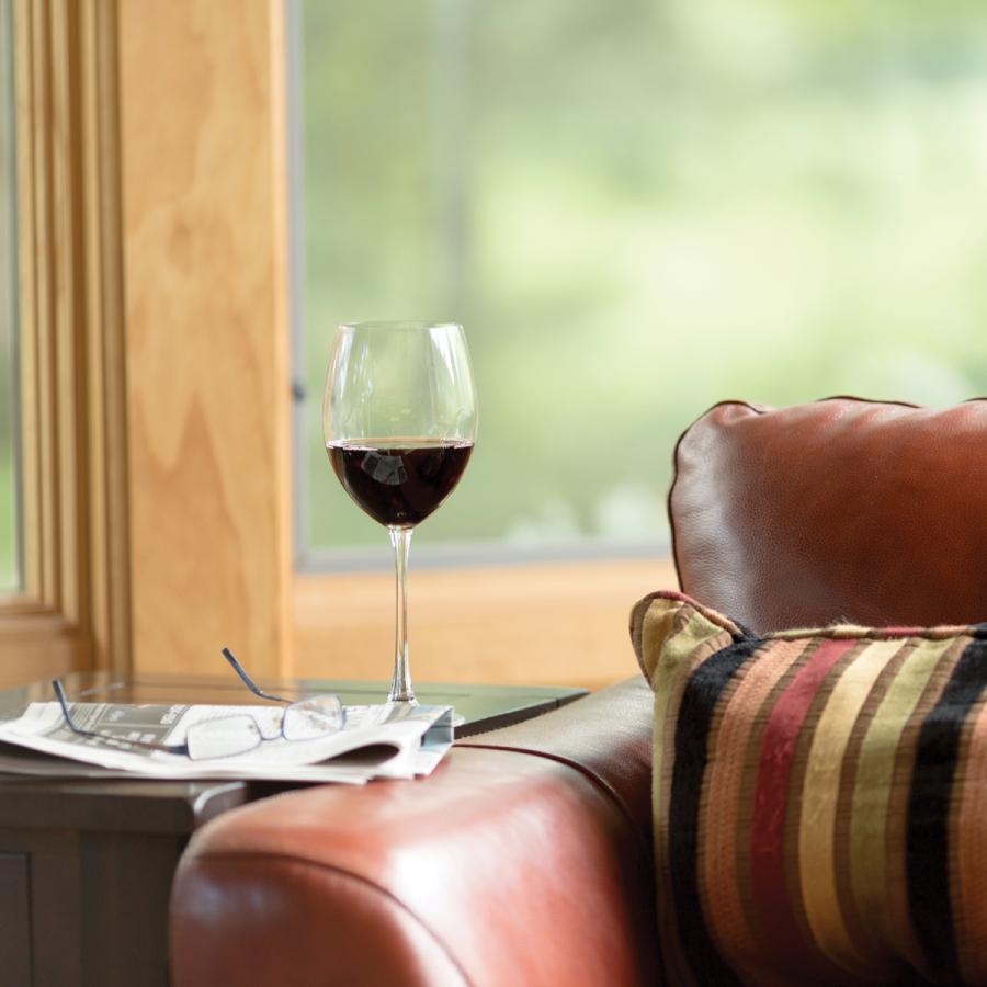 Wine glass on end table next to couch