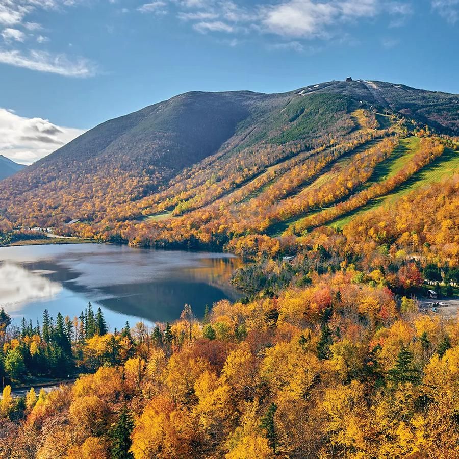 Fall foliage scene with hills and lake