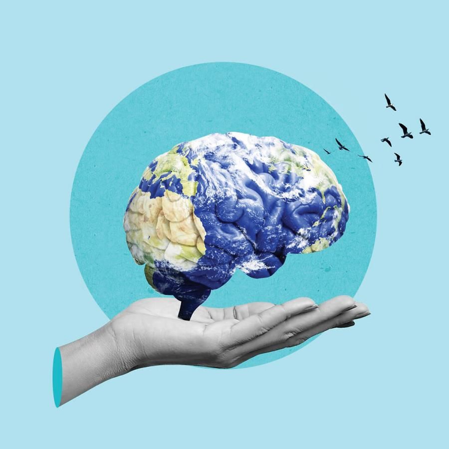 Hand holding a brain with planet Earth superimposed over it