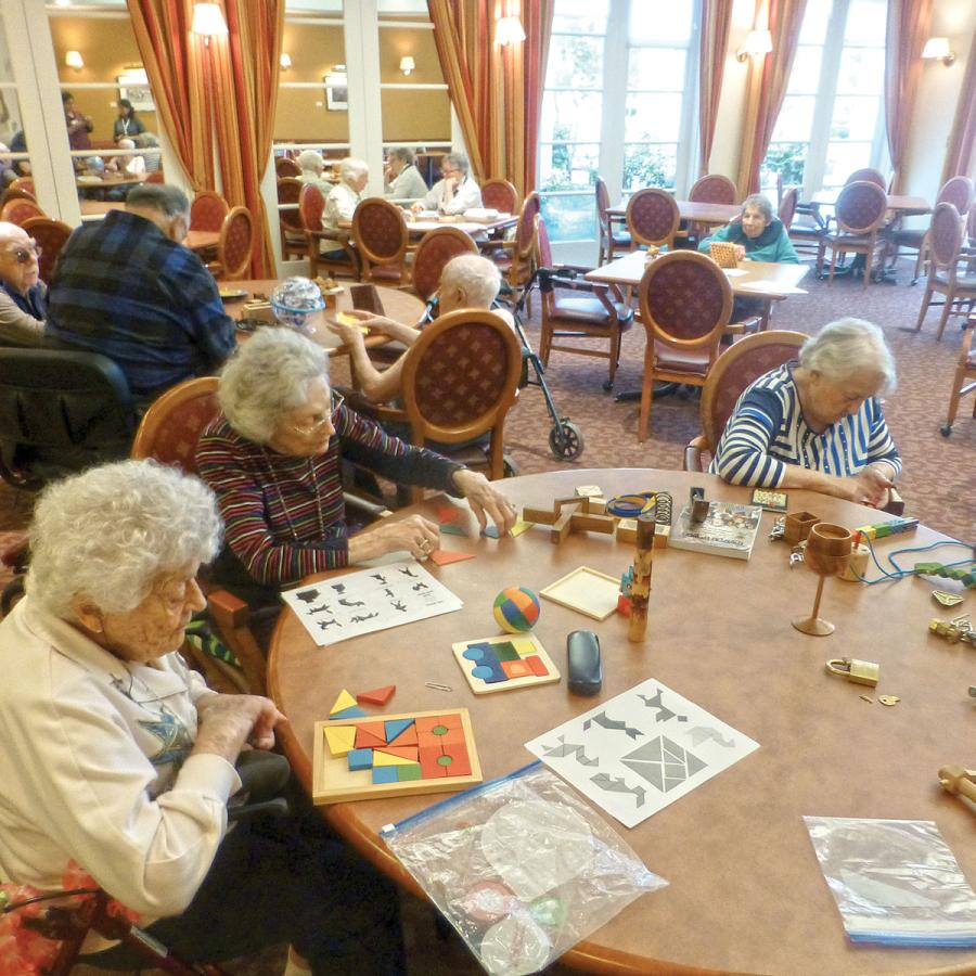 Older adults playing with various games at tables