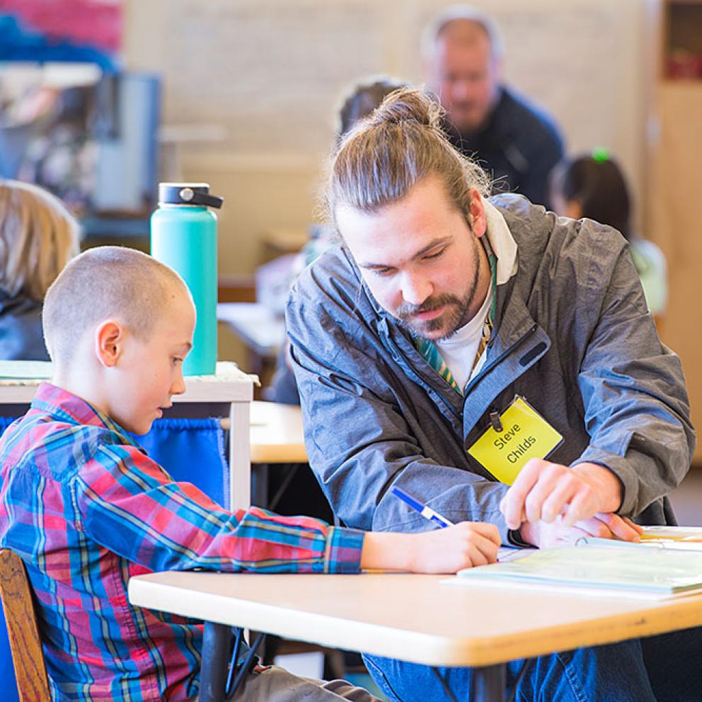 Credential student working with a child in the classroom