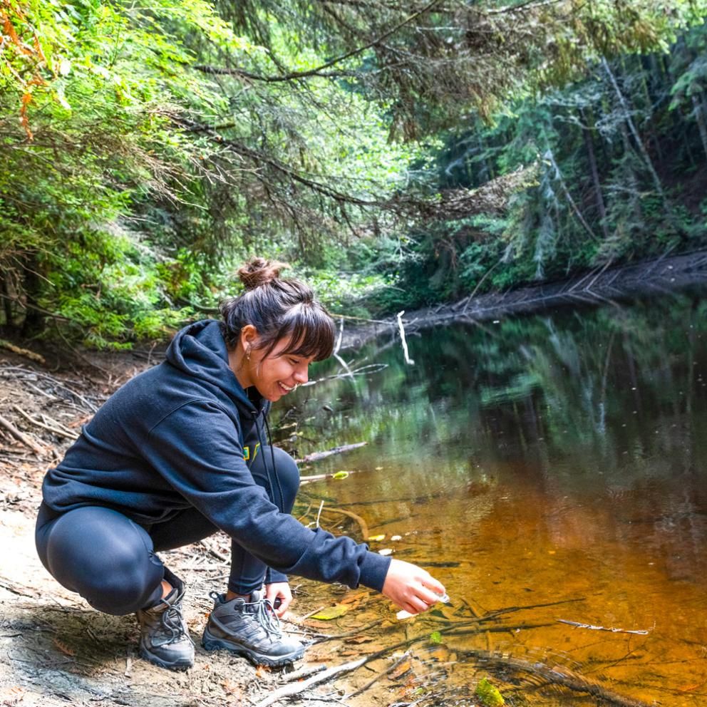 student taking a sample from the water