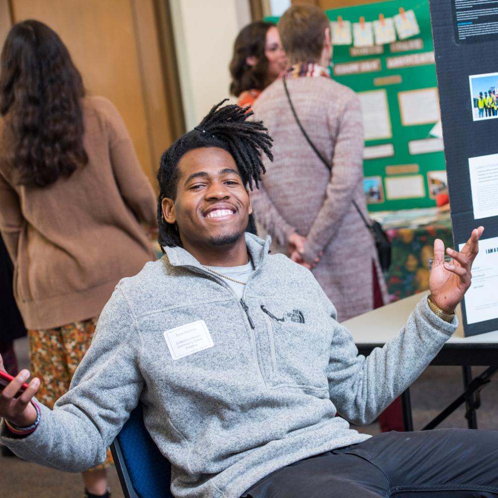 student sitting in a chair in front of a presentation