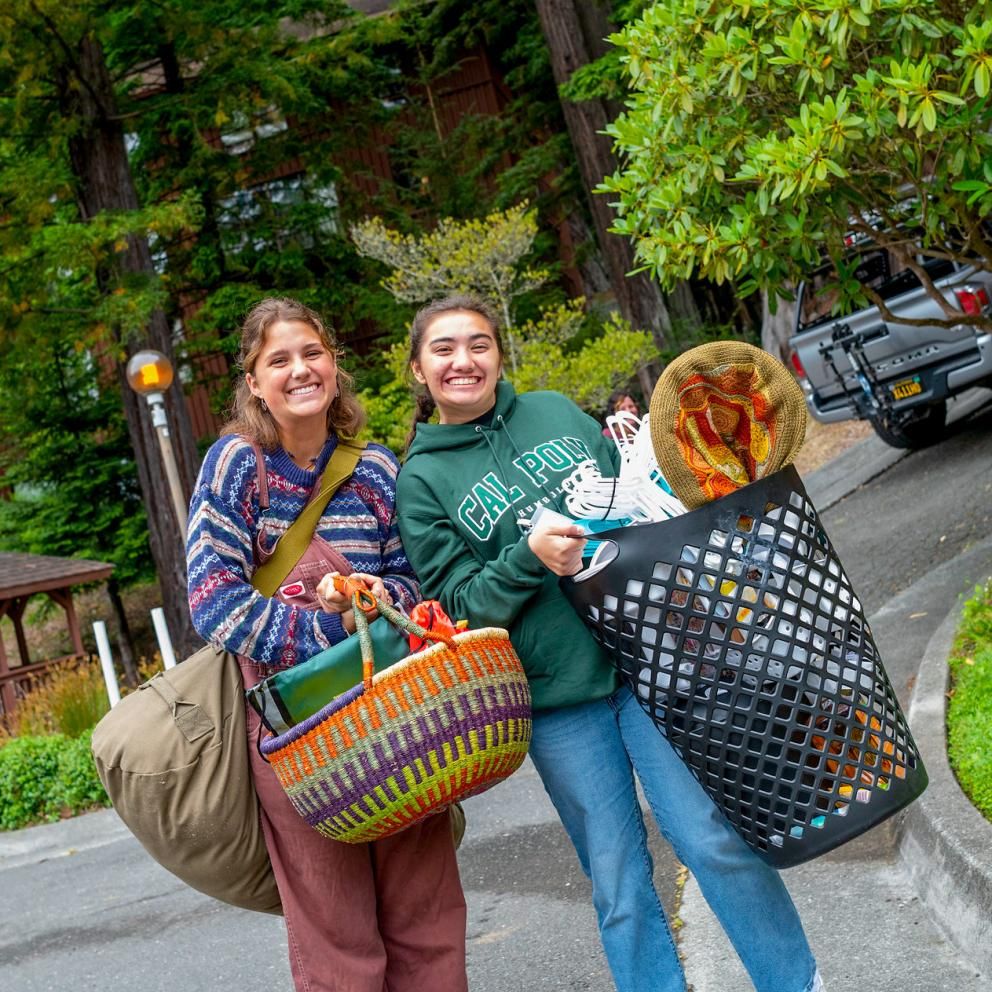 two students carrying things during move in