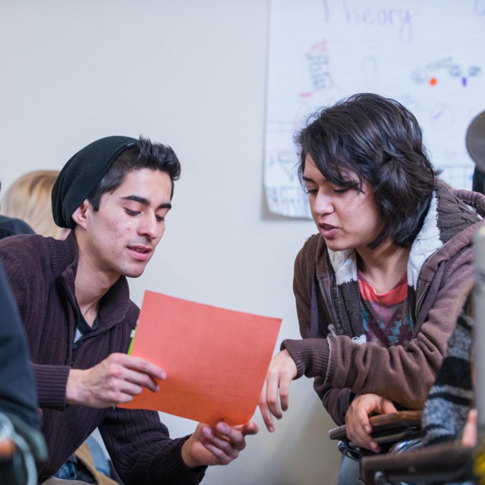 two students looking at a piece of paper