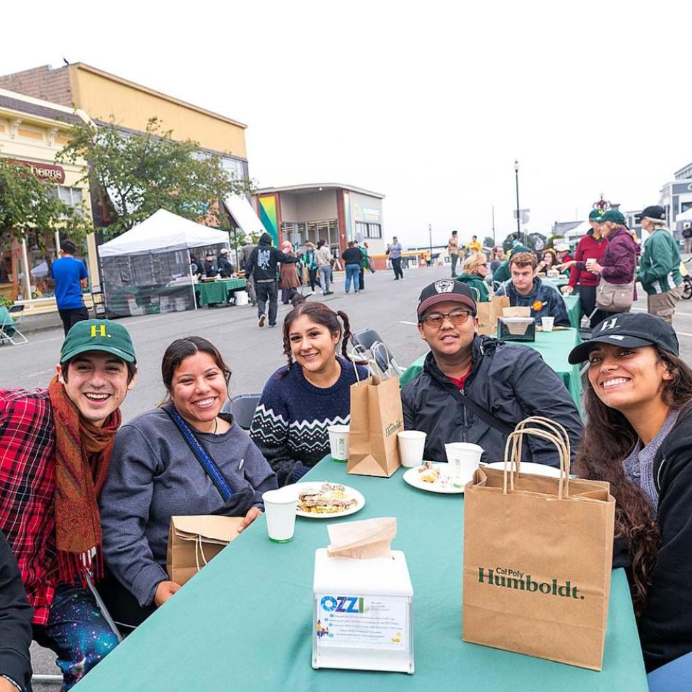 Students sitting around a table outside