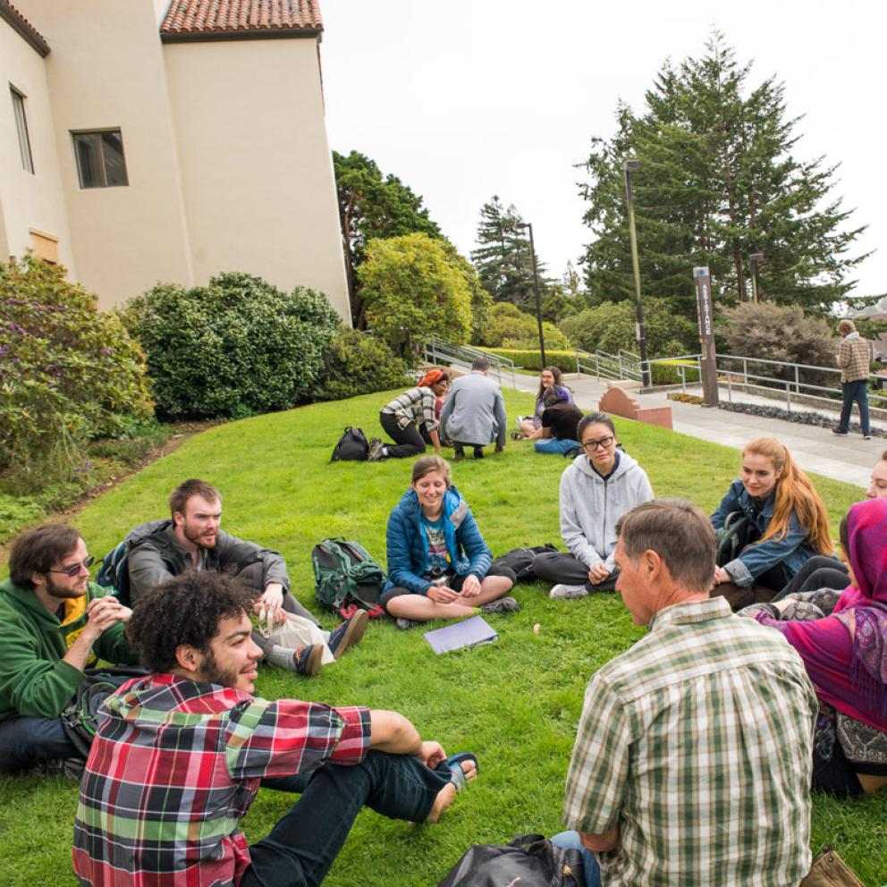 students sitting in a circle with a professor