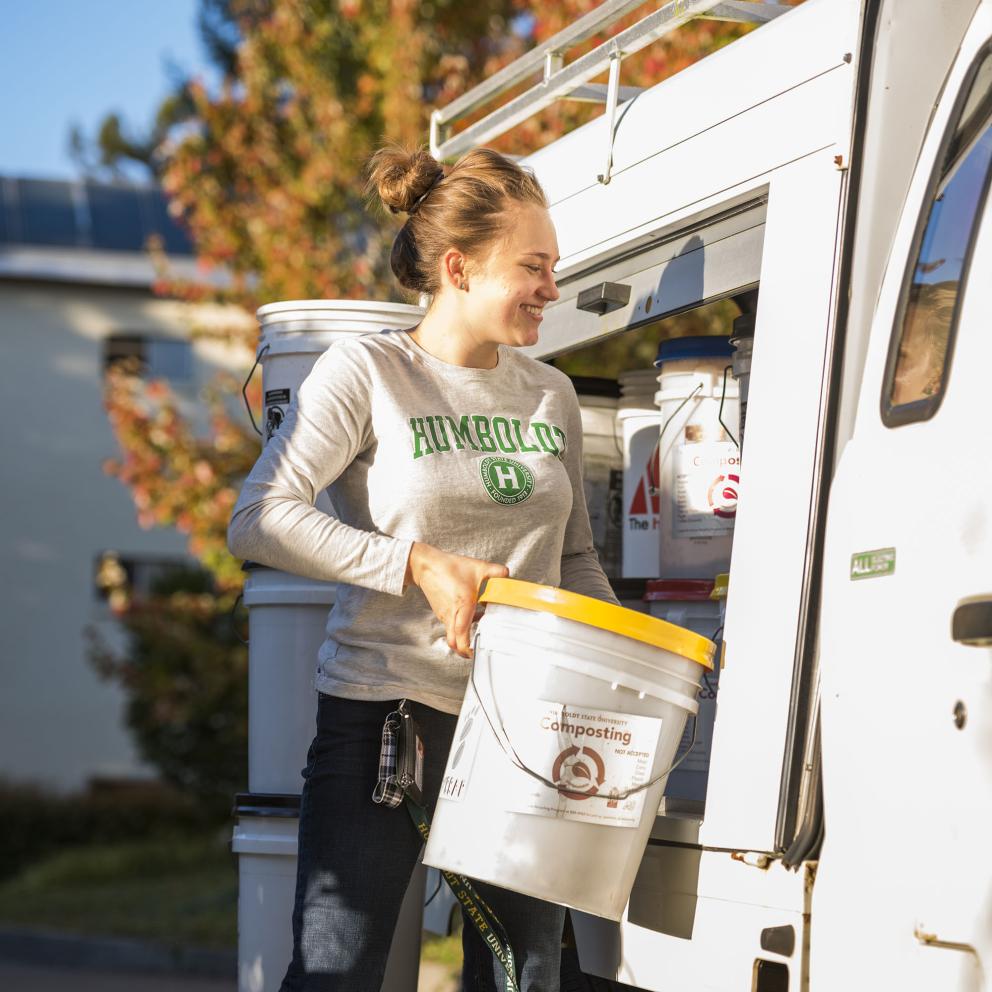 A woman with a compost bucket